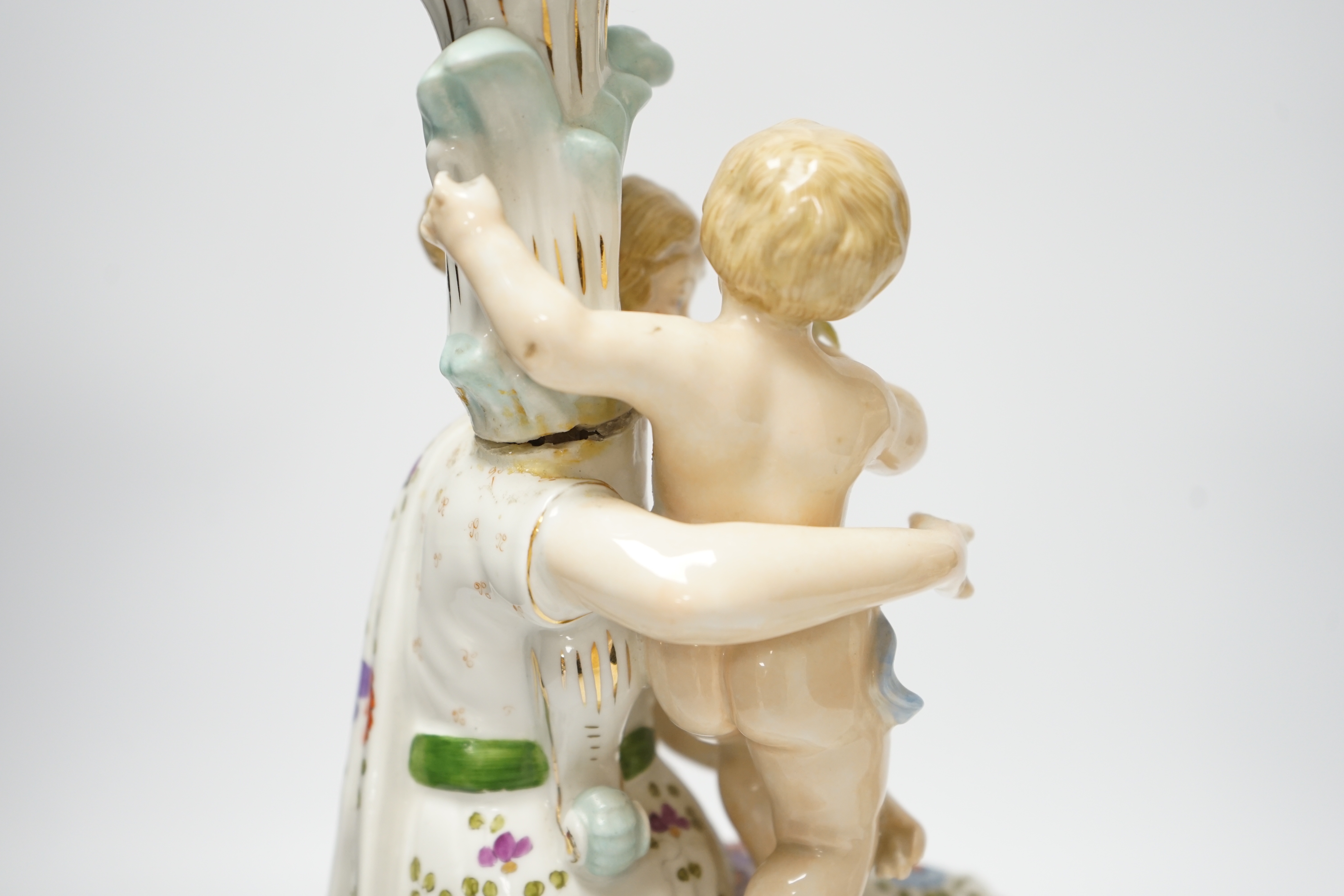 A pair of German floral encrusted porcelain candlesticks of a mother and child group, 38cm high